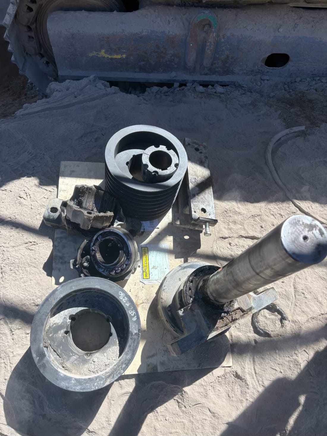 Dismantled crusher drive components laid out