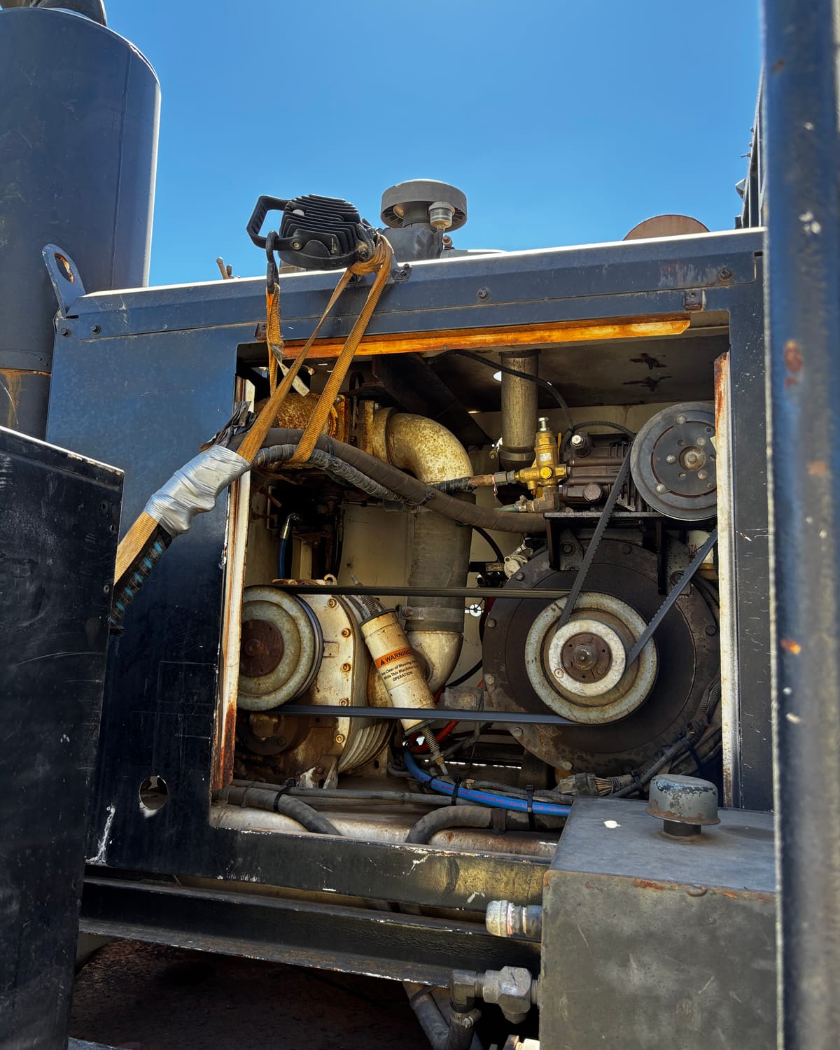 Engine bay with belts and pump